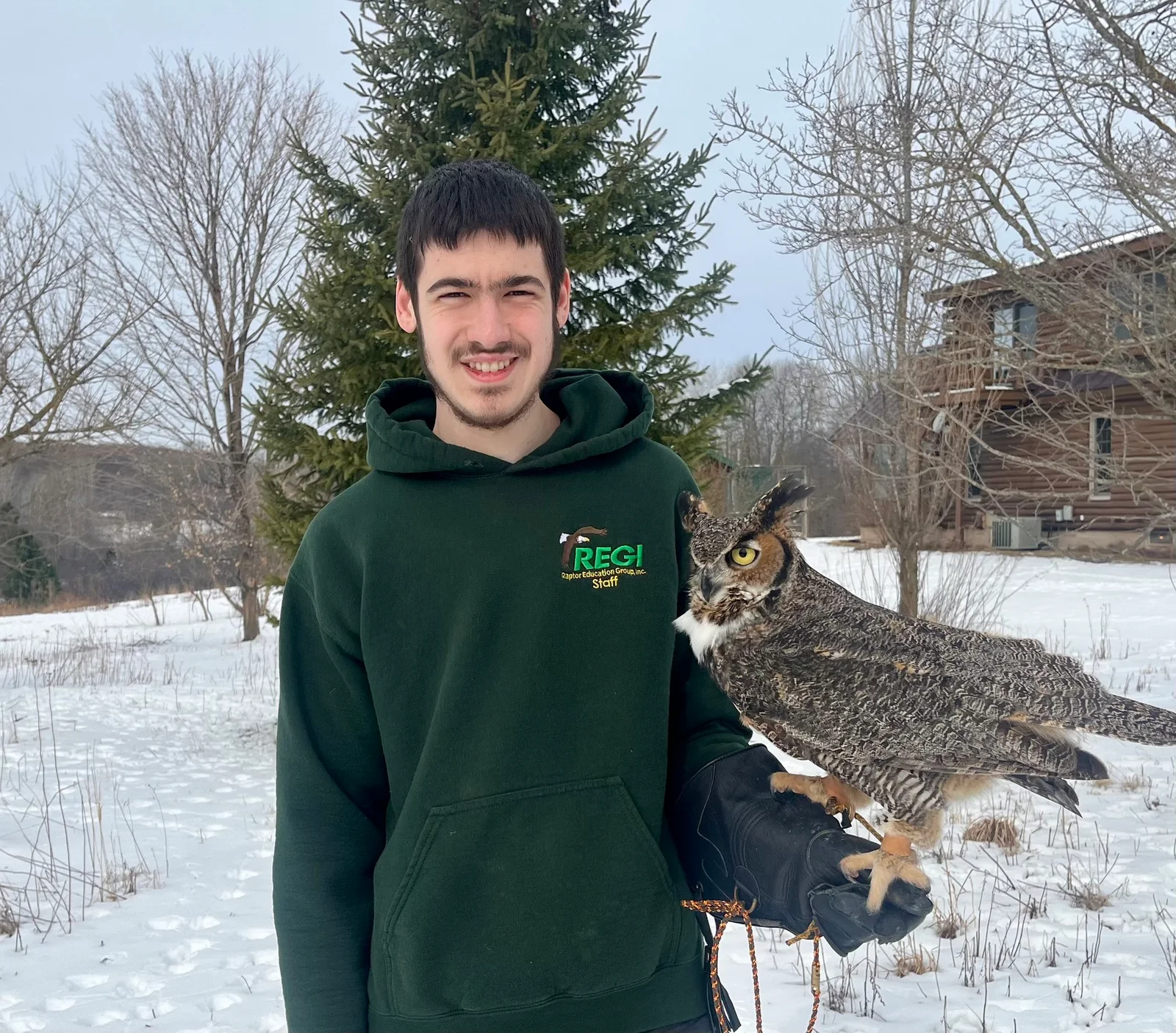 Adam Scott holding a great horned owl